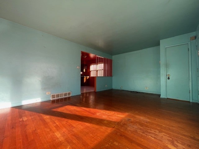 unfurnished living room with wood-type flooring