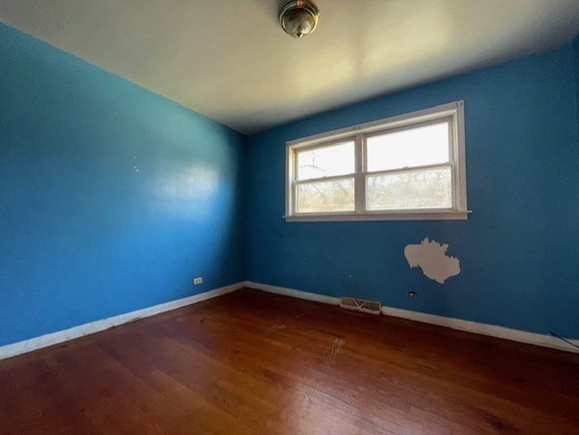 spare room with dark hardwood / wood-style flooring