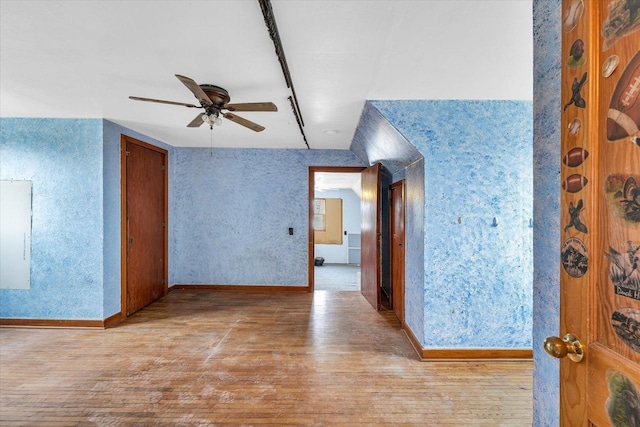 empty room with ceiling fan and light wood-type flooring