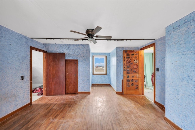 unfurnished bedroom with ceiling fan and hardwood / wood-style floors