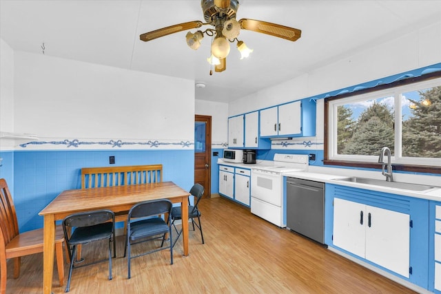 kitchen with dishwasher, sink, white electric range, and tile walls