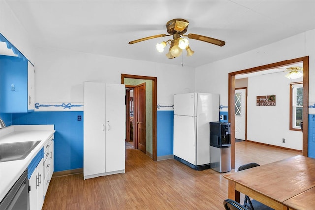 kitchen with sink, light hardwood / wood-style flooring, white refrigerator, stainless steel dishwasher, and white cabinets