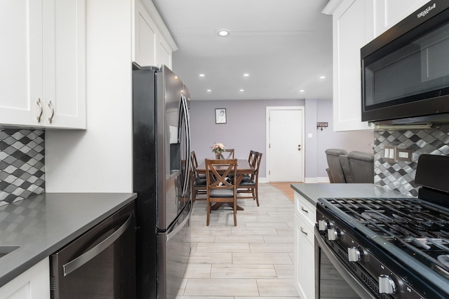 kitchen with white cabinetry, decorative backsplash, and black appliances