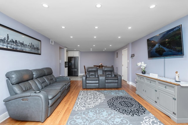 living room with light hardwood / wood-style flooring