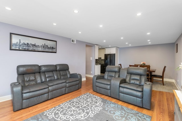 living room with light hardwood / wood-style flooring