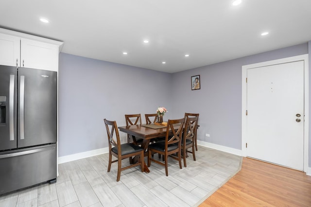 dining space with light hardwood / wood-style floors