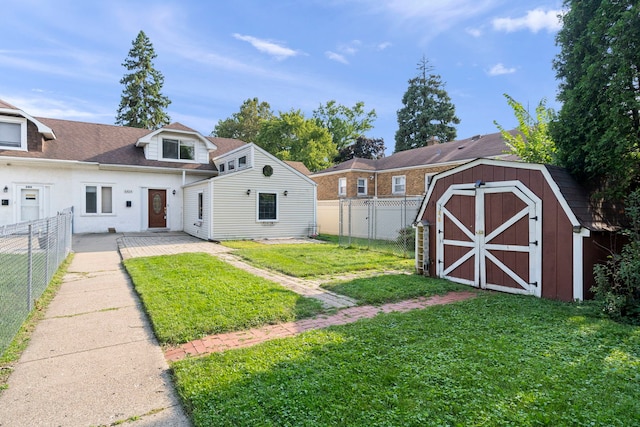 view of front of property featuring a shed, a patio area, and a front lawn