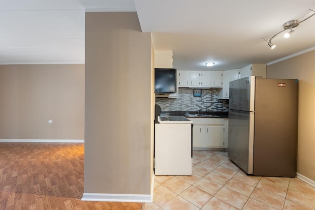 kitchen featuring stainless steel refrigerator, sink, backsplash, white cabinets, and range