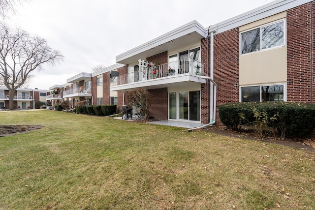 back of property featuring a lawn and a patio area