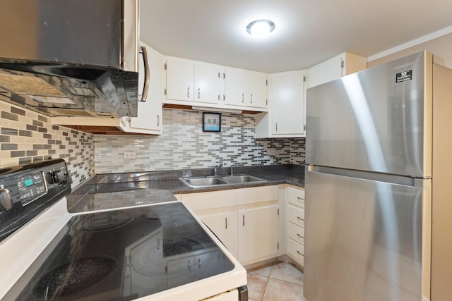 kitchen featuring sink, stainless steel refrigerator, black range with electric stovetop, white cabinets, and light tile patterned flooring