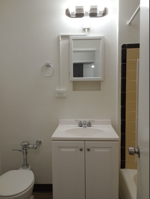 full bathroom featuring independent shower and bath, vanity, and toilet