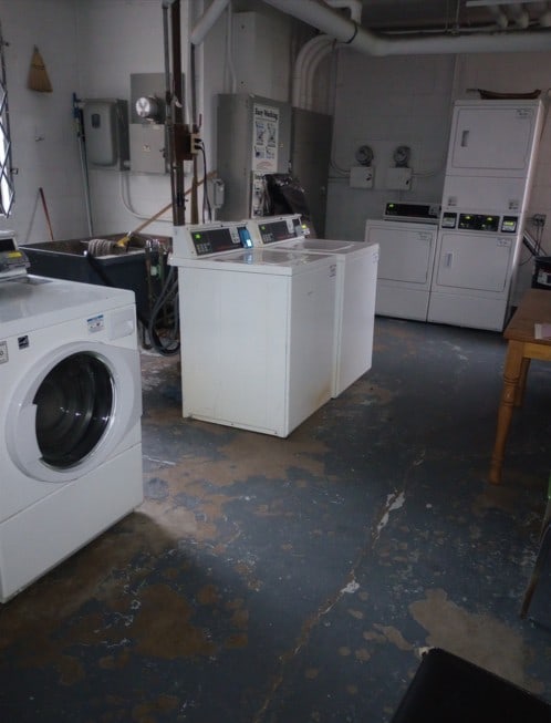 laundry room with stacked washer and dryer and washer and clothes dryer