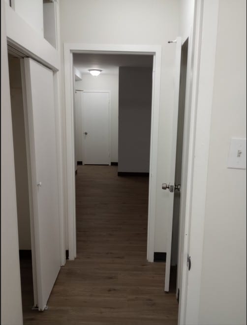 corridor with dark hardwood / wood-style floors