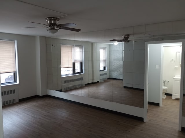 empty room with ceiling fan and radiator heating unit