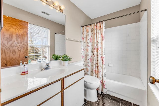 full bathroom with shower / tub combo with curtain, vanity, tile patterned floors, and toilet