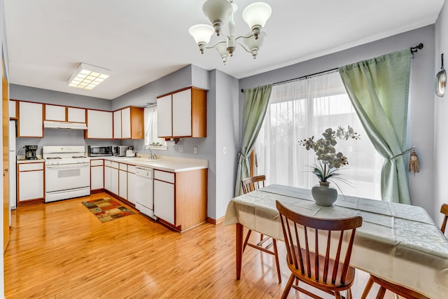 kitchen featuring white cabinetry, sink, a chandelier, light hardwood / wood-style floors, and white appliances