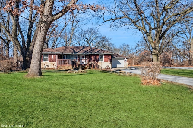 ranch-style house with a garage, a front yard, and covered porch