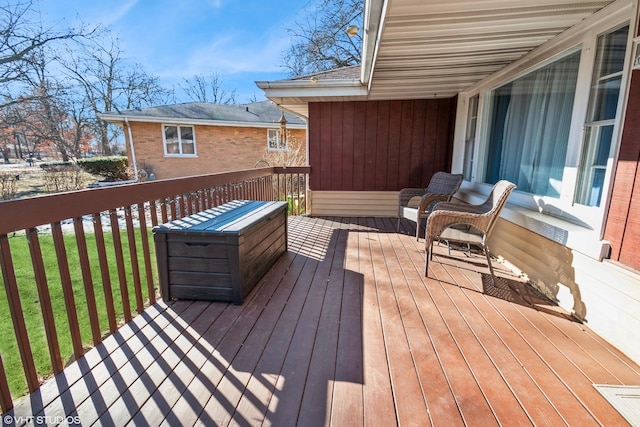 wooden deck with a lawn