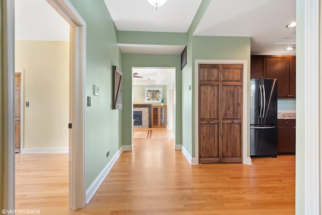 corridor with light hardwood / wood-style floors