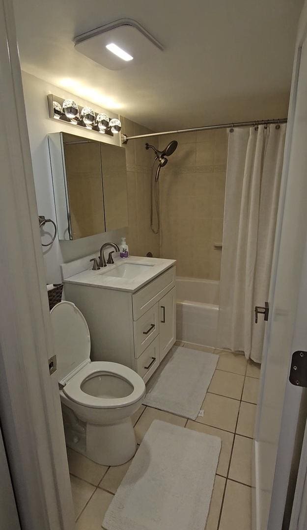 full bathroom featuring tile patterned flooring, vanity, shower / bath combination with curtain, and toilet