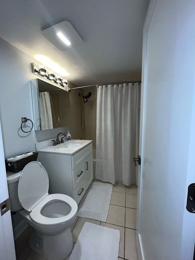 full bathroom featuring vanity, tile patterned floors, shower / bath combo with shower curtain, and toilet