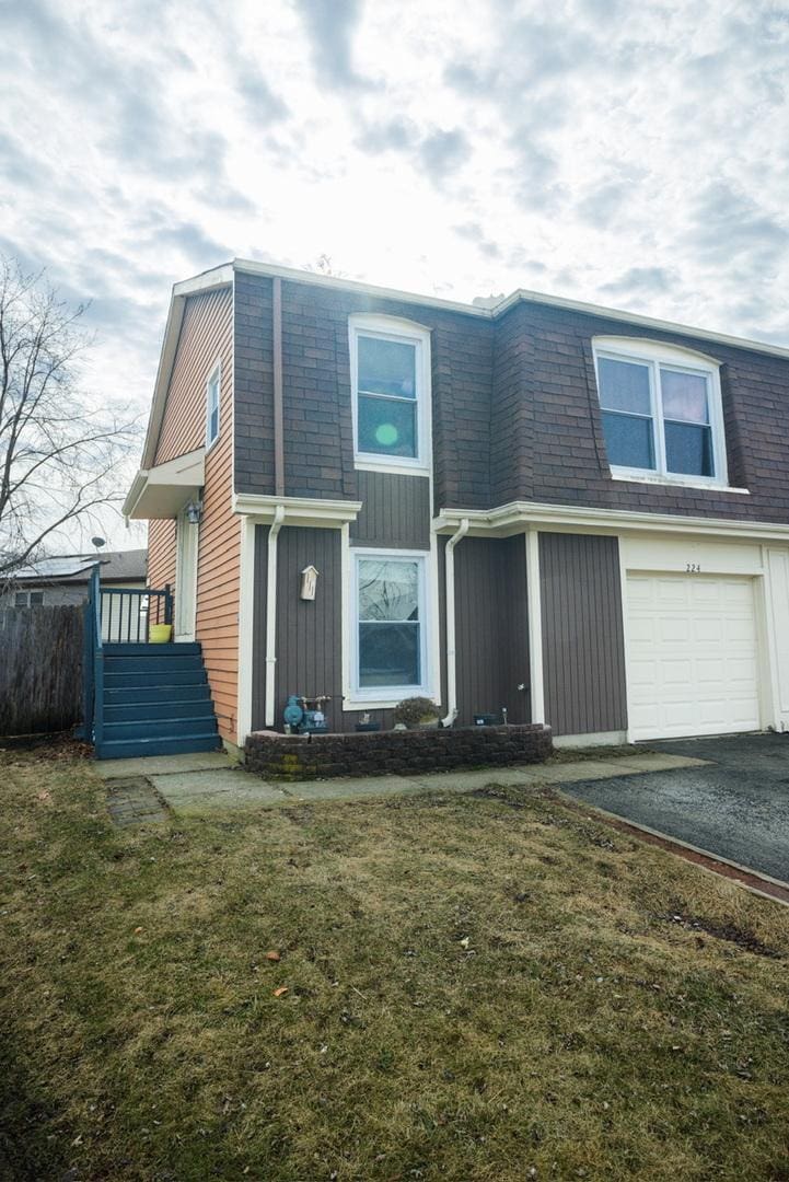 view of front of home featuring a garage and a front yard