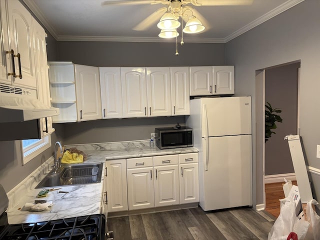 kitchen featuring white refrigerator, dark wood-type flooring, sink, and white cabinets