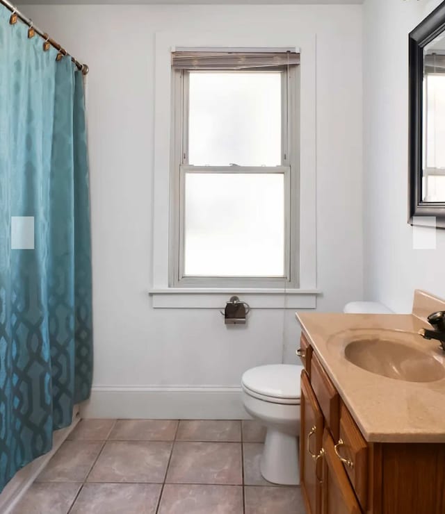 bathroom with tile patterned flooring, vanity, a shower with curtain, and toilet