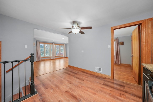 unfurnished living room with light hardwood / wood-style flooring and ceiling fan