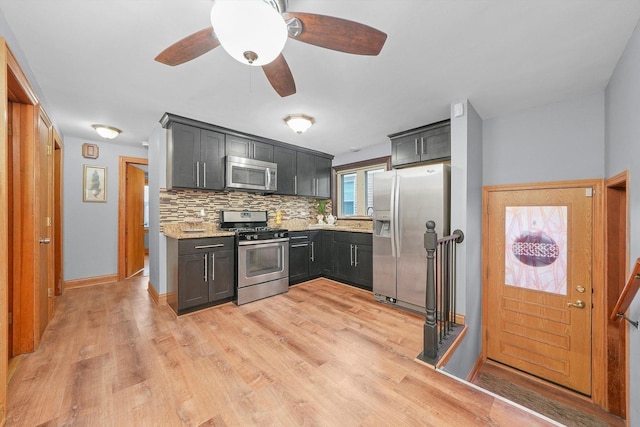 kitchen featuring light hardwood / wood-style flooring, ceiling fan, stainless steel appliances, light stone counters, and tasteful backsplash