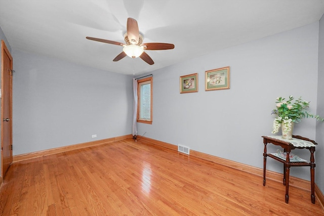 empty room featuring ceiling fan and light hardwood / wood-style flooring