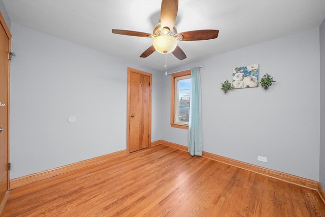 spare room featuring ceiling fan and light hardwood / wood-style flooring