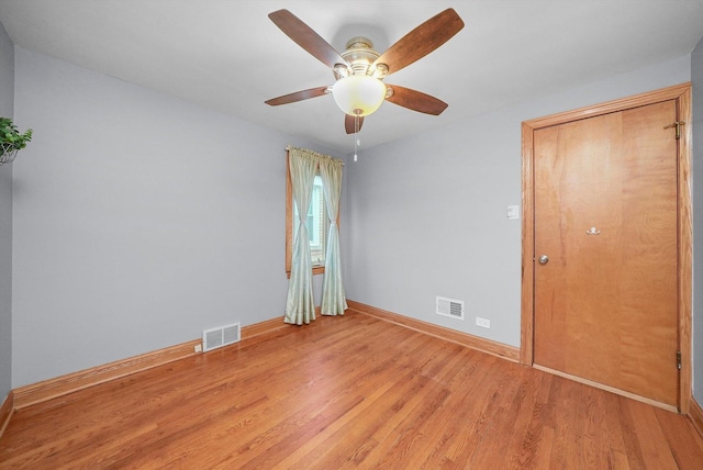 empty room with light hardwood / wood-style flooring and ceiling fan