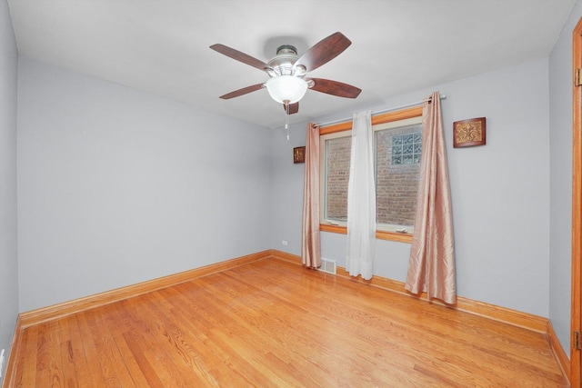 spare room with ceiling fan and light wood-type flooring