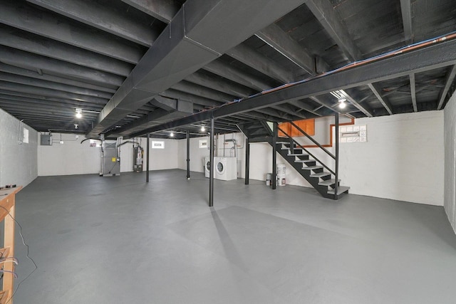 basement with plenty of natural light, washing machine and dryer, heating unit, and gas water heater