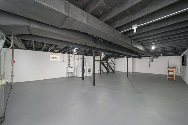 basement featuring separate washer and dryer and sink