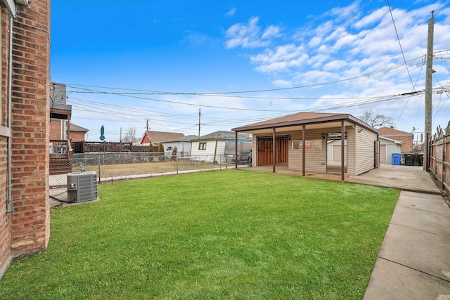 view of yard with an outbuilding, a patio area, and central air condition unit