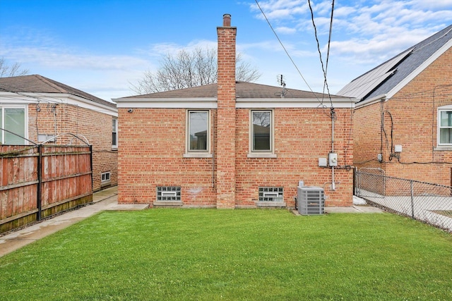 back of property featuring a yard and cooling unit