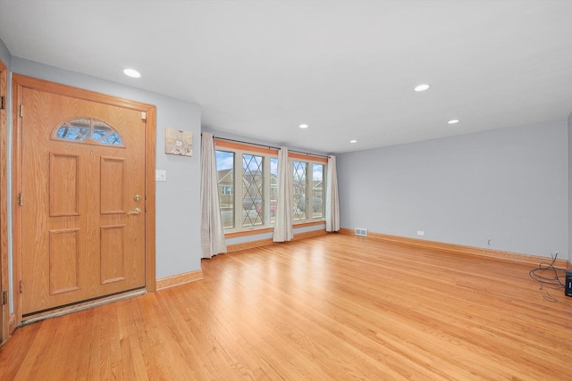 foyer entrance with light wood-type flooring