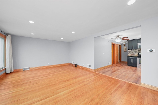 unfurnished room with ceiling fan and wood-type flooring