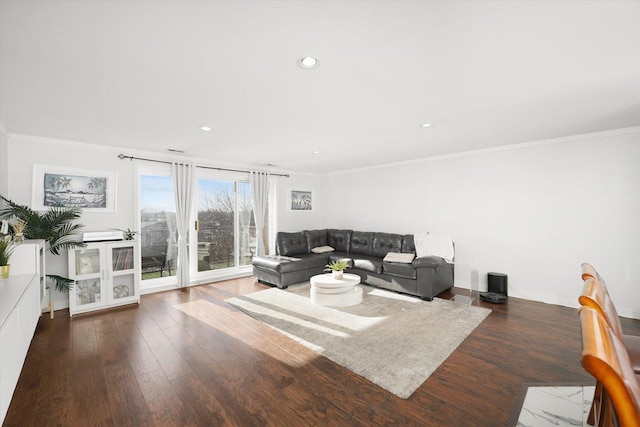 living room with dark wood-type flooring and ornamental molding