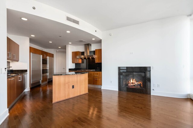 empty room with dark wood-type flooring, a wall of windows, and a water view