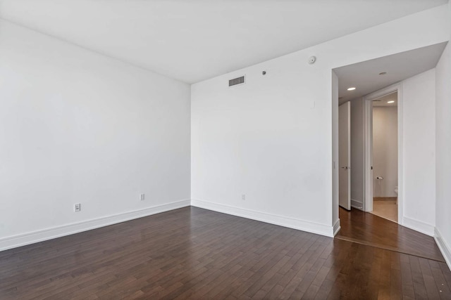 empty room with dark wood-type flooring