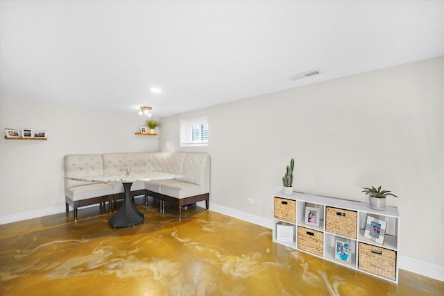 living area with concrete floors