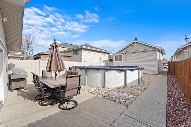 view of patio featuring area for grilling and a covered pool