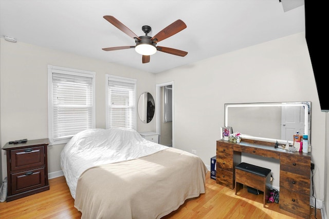 bedroom with light hardwood / wood-style flooring and ceiling fan