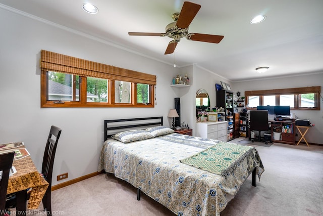 carpeted bedroom featuring crown molding and ceiling fan