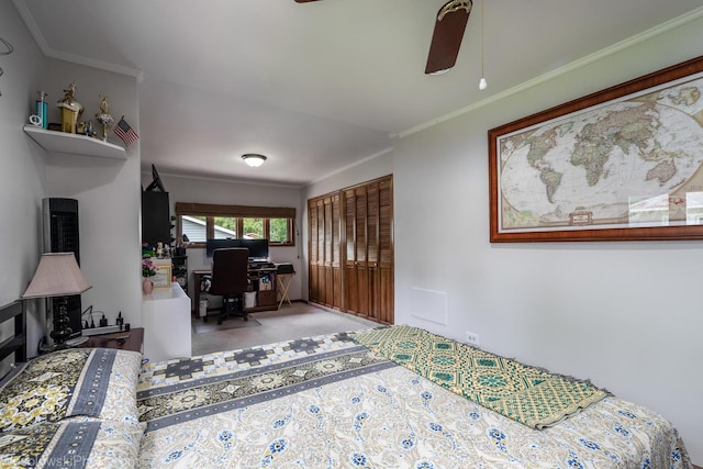 carpeted bedroom with ceiling fan and ornamental molding