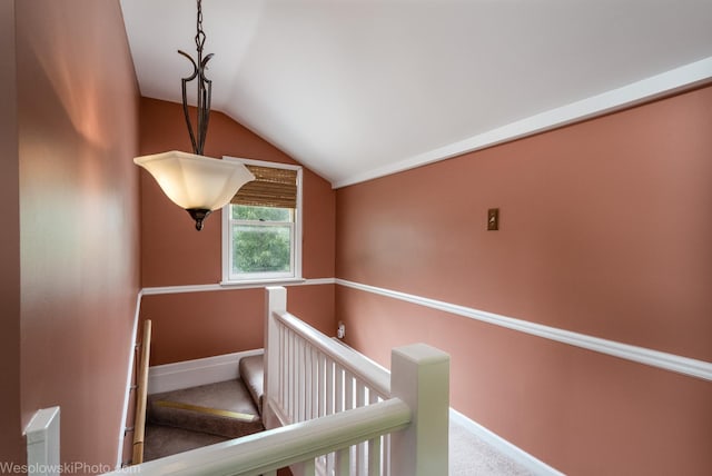 hallway with lofted ceiling and carpet floors