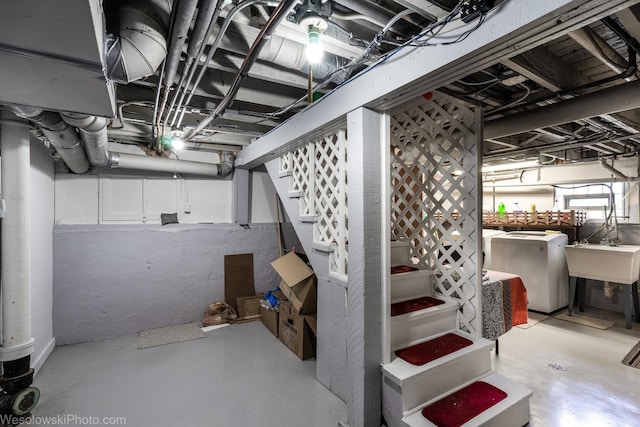 basement with washer and dryer and sink